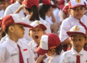 Seorang siswa menguap menahan kantuk sebelum upacara di SD. Foto: Faizal Fanani/Hibata.id