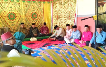 Bupati Bone Bolango, Ismet Mile dan Wakil Bupati, Risman Tolingguhu menjalani prosesi Adat Mopotilolo di Kecamatan Suwawa Tengah, Kamis (12/6/2025). (F.AKP)/Hibata.id