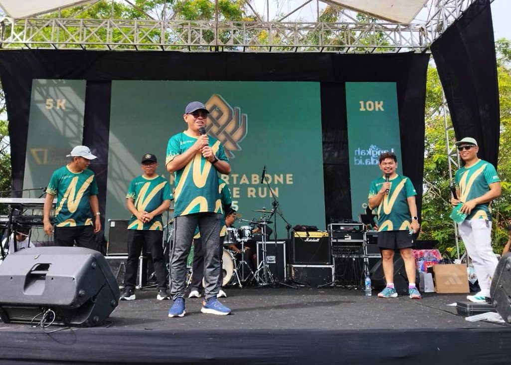 Sekda Iwan Mustapa memberikan sambutan sekaligus menyerahkan bonus kepada tiga pelari tercepat kategori 10 kilometer pada kegiatan Nani Wartabone Heritage Run 2025, di Alun-Alun Bone Bolango, Minggu (24/8/2025). (F.AKP-Diskominfo)/Hibata.id