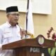 Sekretaris Daerah (Sekda) Kota Gorontalo, Ismail Madjid, saat memberikan sambutan di seminar yang digelar Persatuan Guru Republik Indonesia (PGRI) Kota Gorontalo di Bandhayo Lo Yiladia, Selasa, 12 Agustus 2025. (Foto: Humas Pemkot Gorontalo)